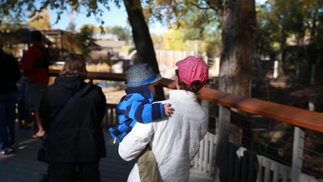 mother and baby walking through zoo