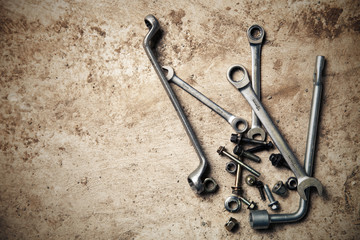 Wrench with nuts and bolt. Space for text.