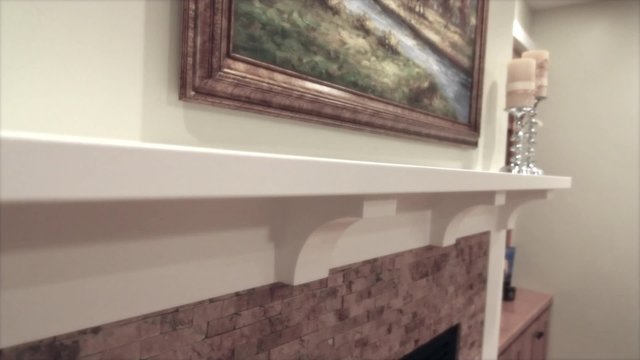 a glass fireplace and a mantle jib shot
