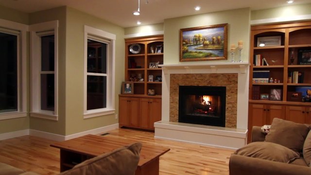 a roaring fireplace in a living room jib shot