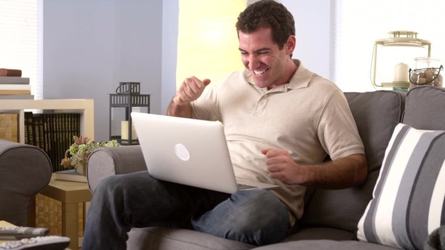 Man watching the game on his laptop