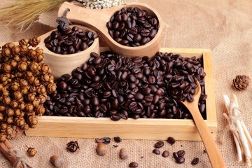 Roasted coffee beans on sack brown background.