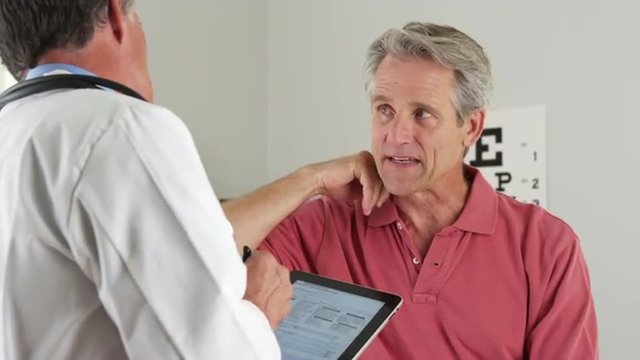 Elderly patient asking doctor about neck pain