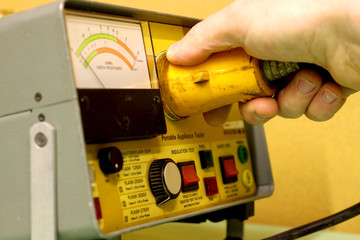 Electrical test equipment operating.
Man using electrical test equipment.