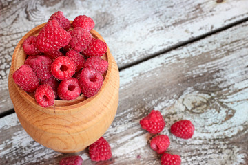 Raspberries in a pot on the table