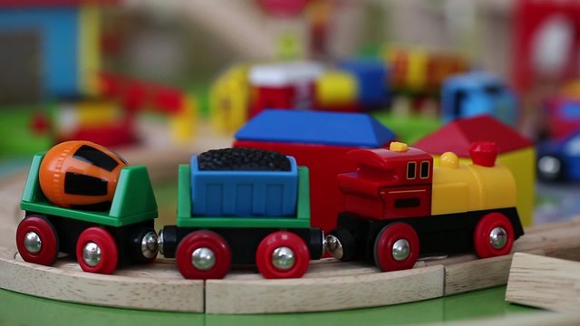 a little boy playing with a toy train