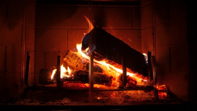A closeup shot of hot fire in a home fireplace