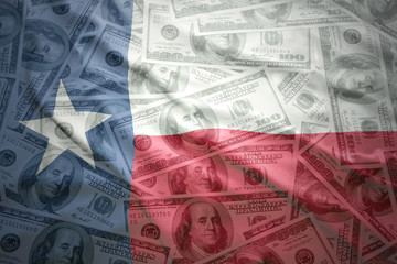 colorful waving texas state flag on a american dollar money background © luzitanija