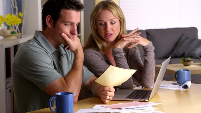 Stressed couple dealing with too many bills