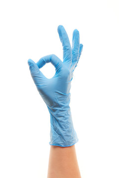 Female Doctor's Hand In Blue Surgical Glove Showing OK Sign