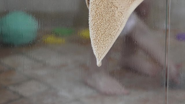 A toddler in the shower with his mother