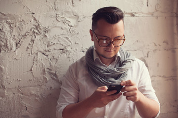 Stylish man using smartphone in startup office