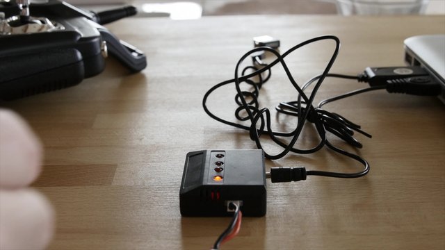 Man plugs in rc batteries to charge