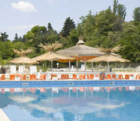 Beach umbrellas near swimming pool