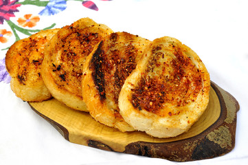 slices of garlic bread with cayenne pepper