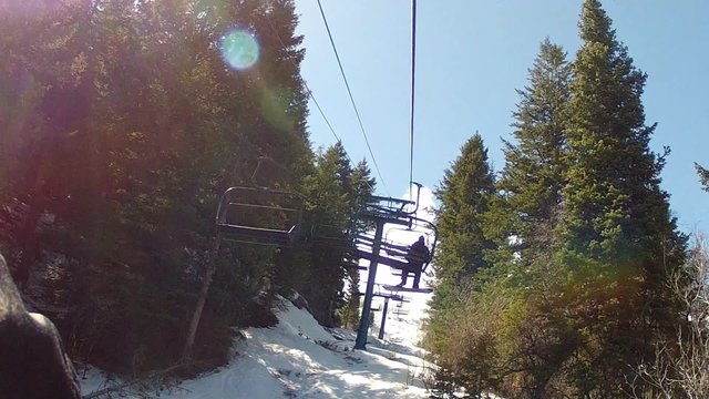 skiers on the chairlift in spring