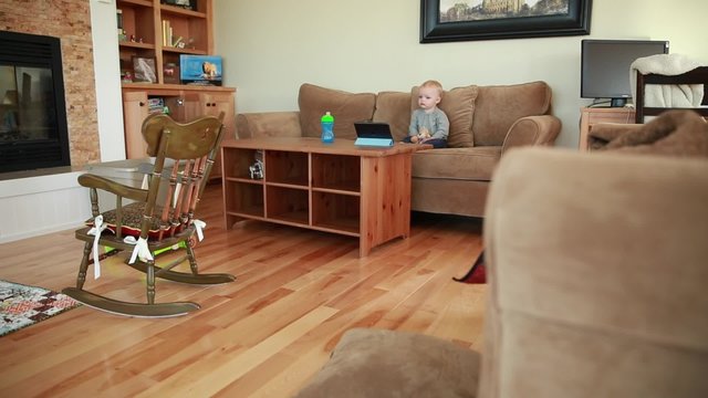 cute baby boy watching show on a tablet