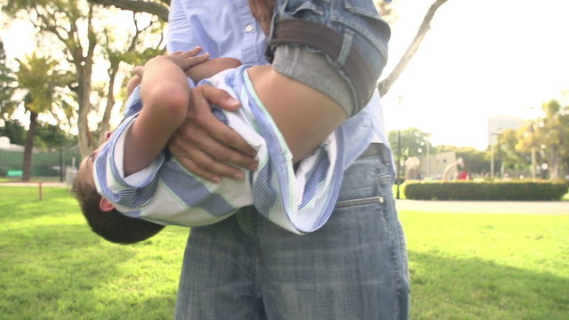 Slow Motion Shot Of Father Playing With Son In Park
