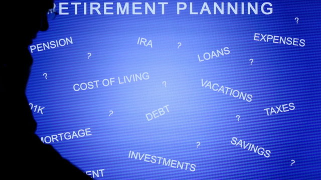 Silhouetted man presenting a retirement planning chart on an LCD screen.