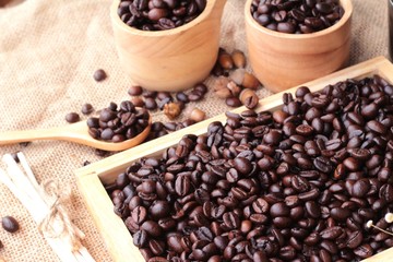Roasted coffee beans on sack brown background.