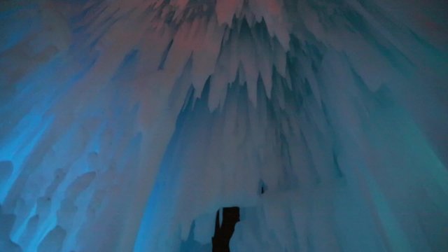 people walking in an ice cave