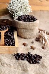 Roasted coffee beans on sack brown background.