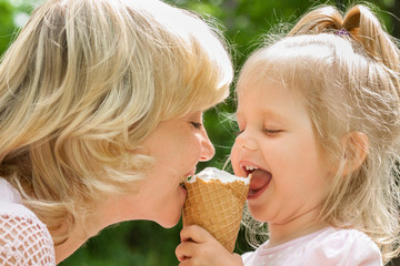 Happy mother and baby enjoy ice cream