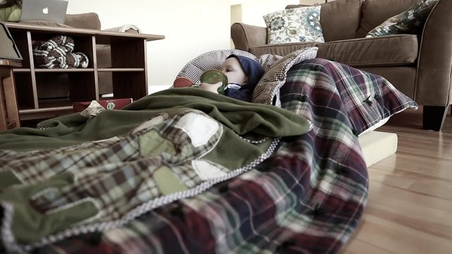 a sick toddler lying on floor next to mother