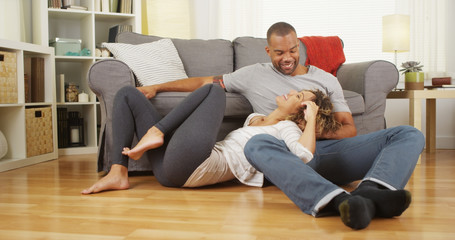 Black couple sitting on floor talking