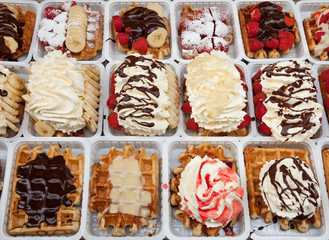Varieties of Take Away Waffles with Chocolate Whipped Cream and Strawberries