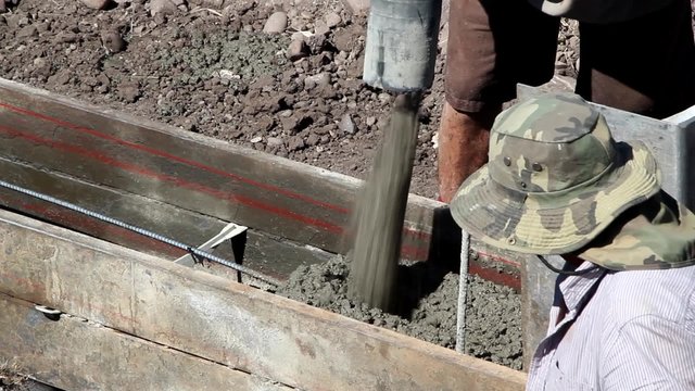 Footings Crew Pouring Cement Closeup