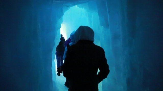 crowd walking in an ice cave