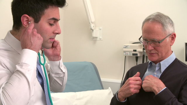 Doctor Listening To Senior Male Patient's Chest