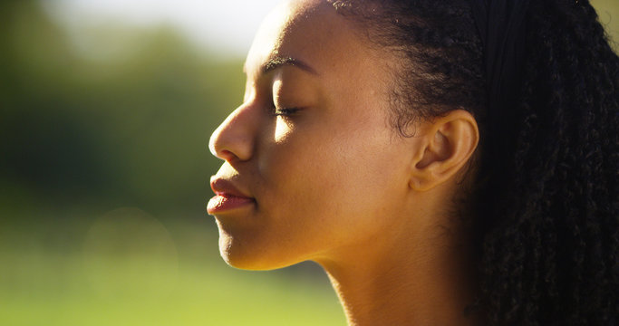 Beautiful black woman feeling the sun on her face