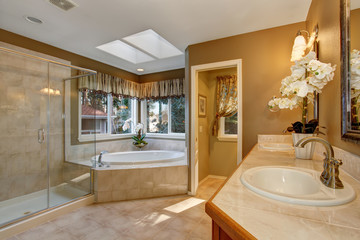 Large elegant master bathroom with tile floors, and glass shower