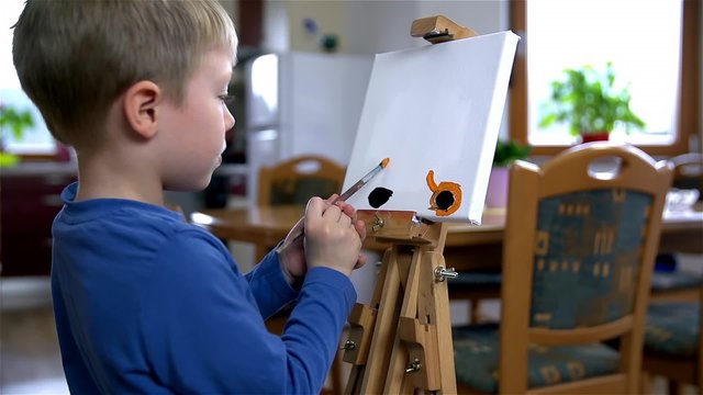 Young Artist Painting On Canvas With Both Hands