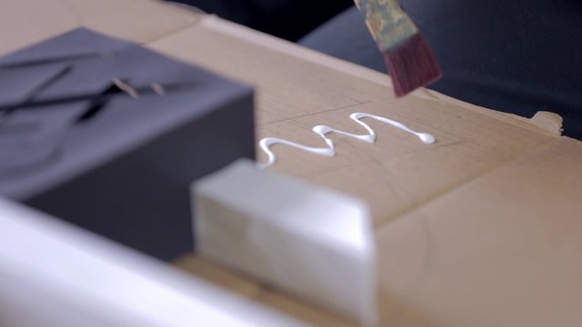 Adding White Glue on Paperboard