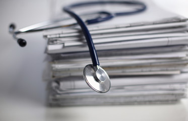 Medical stethoscope on the stack of paper, Medical stethoscope