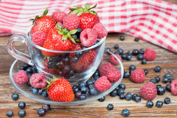 mixed berries in a a transparent cup
