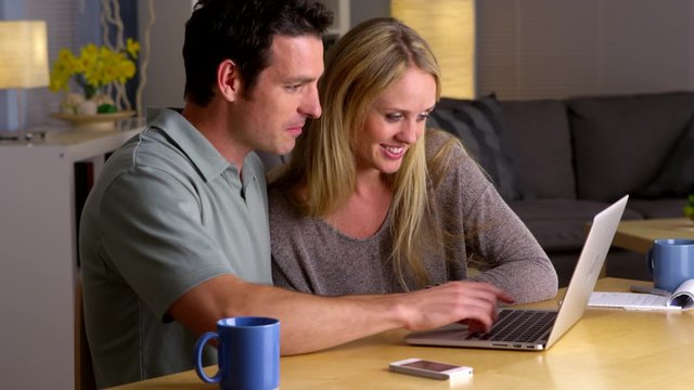Happy couple surfing the internet together