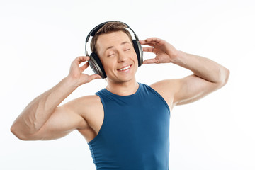 Beautiful young man is relaxing with earphones