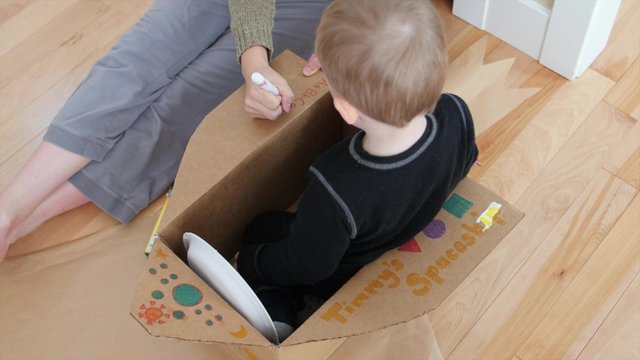 A mother makes a spaceship with her toddler