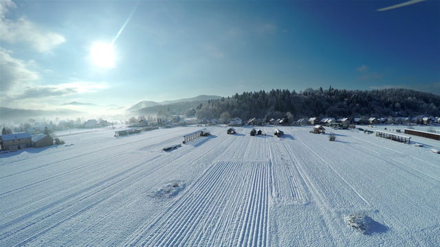 Flying high above countryside in snow