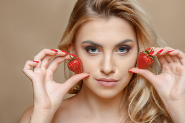 Attractive young woman with red sweet berry