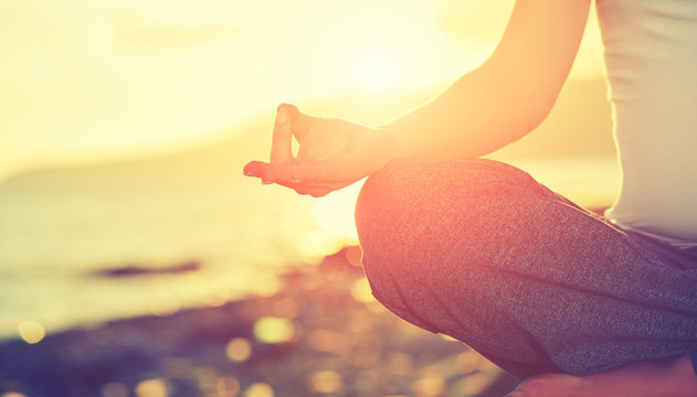 Yoga Concept. Hand Woman Practicing Lotus Pose On Beach