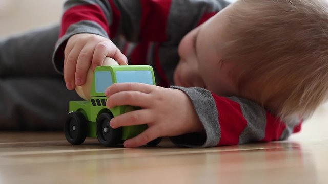 little boy plays with toy truck