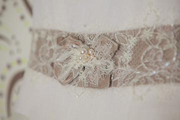 Close up of a wedding dress with large silk bow
