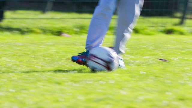 Soccer ball on green field close up