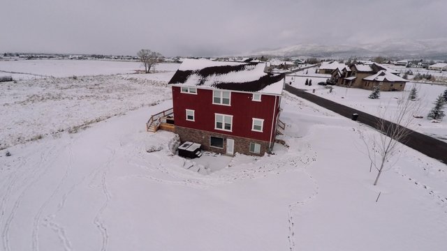 A high aerial shot of a large estate after a winter snow storm