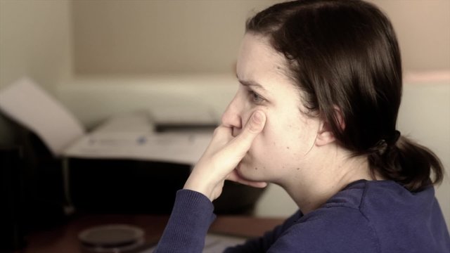 woman works in a home office on computer and ipad